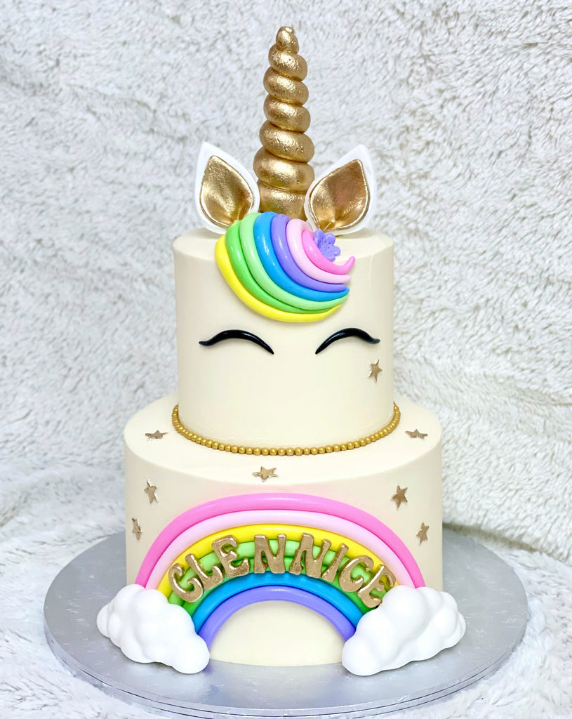 https://www.seipatisserie.com/cdn/shop/files/2-TierUnicornRainbowCake_1024x1024.jpg?v=1684245395